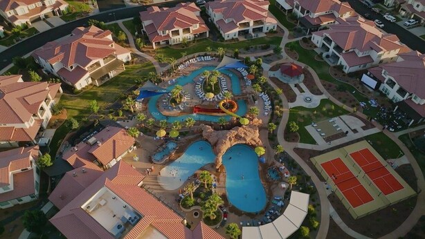 An aerial view of a residential area with houses, a swimming pool complex, and tennis courts. - Arcadia 64 | Private Hot Tub * Views * Arcade * Pool Table (Santa Clara)