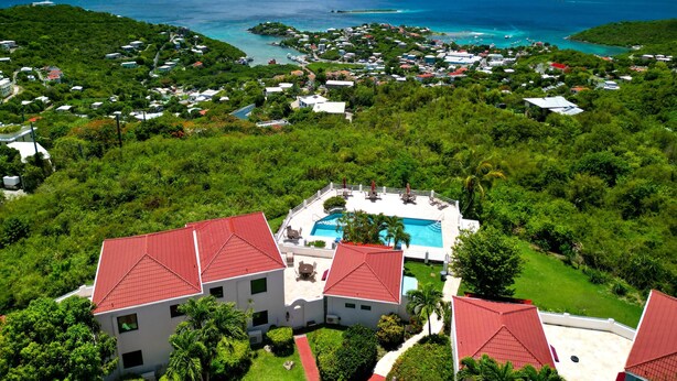 A resort with multiple buildings, a swimming pool, and a view of the sea and islands. - 2 Bedroom Villa with Pool & Panoramic Views (Cruz Bay)