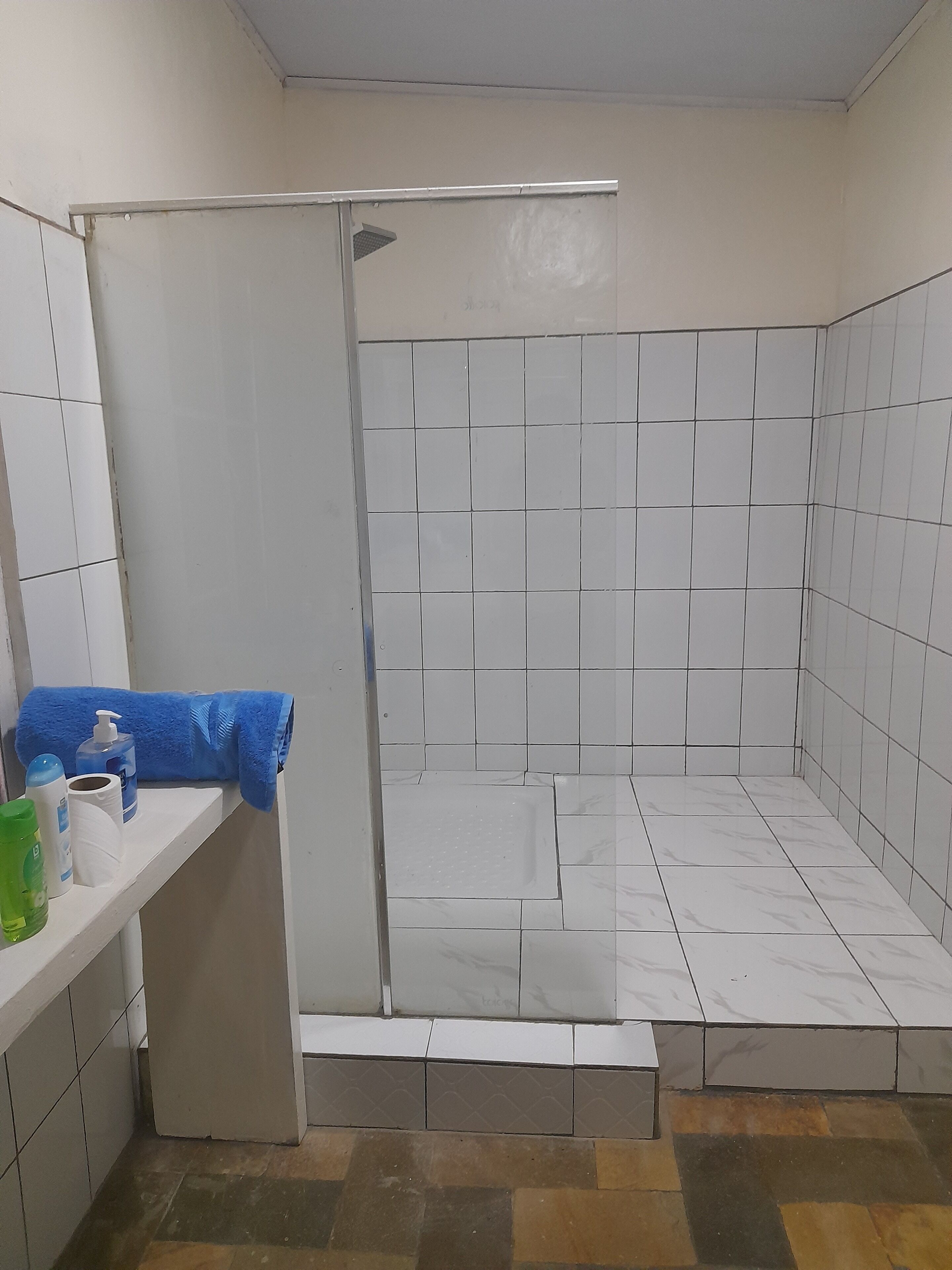 Shower, rainfall showerhead, designer toiletries, slippers