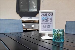 A sign on a table encouraging sharing experiences on social media with hashtags.
