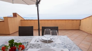 A table set for two on a terrace with a view of the sea. - Welcomely - Villa Paola B (Muravera)