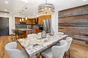 Enjoy cooking in this well-equipped kitchen with a large island, stainless steel appliances, and ample cabinetry.