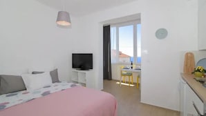 A bedroom with a bed, a TV, a desk, and a chair. - Apartment Miriam - Studio Apartment With Sea View (Dubrovnik)