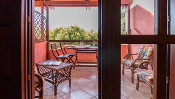 Enjoy a meal on the balcony with a view of the lush garden.