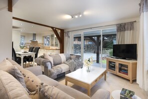 A modern living room with a sofa, coffee table, and TV stand. - The Pavilion, Clappersgate (Clappersgate)