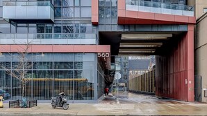 Un edificio moderno con amplios ventanales y fachada roja.