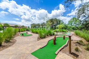 Play a round of golf amidst lush greenery and scenic obstacles.