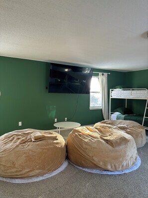 Relax in this cozy space with a flat-screen TV, a comfortable bunk bed, and two bean bags.