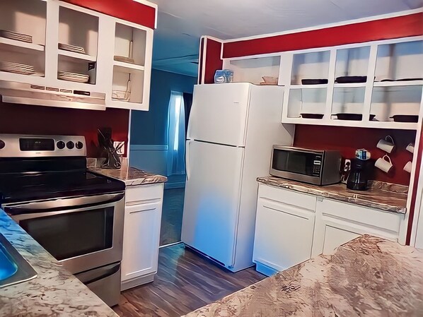 Enjoy cooking in this well-equipped kitchen with a stainless steel oven, microwave, and refrigerator.