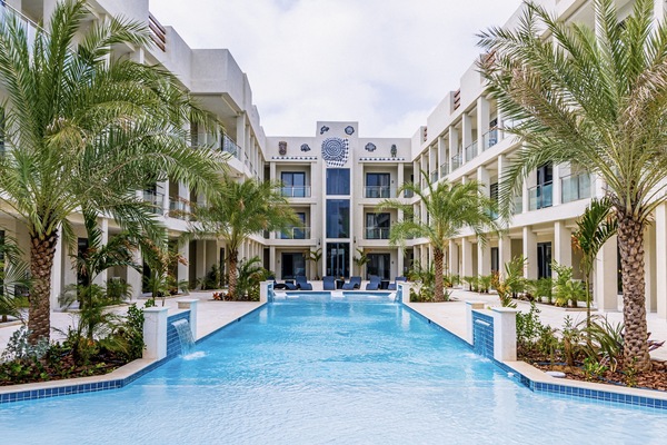 Resplendent Pool in Noord Aruba near Palm Beach - Relax by the shimmering poolside oasis - Crystal Clear Water - Plants and Trees introduce freshness and visual interest