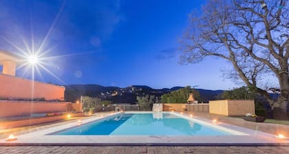 Villa with swimming pool surrounded by greenery in a panoramic location