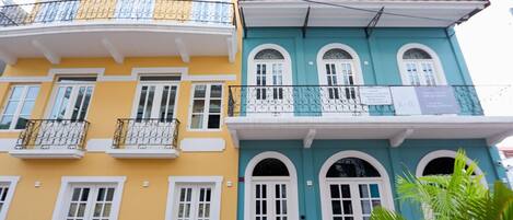 A multi-story building with balconies and arched windows.