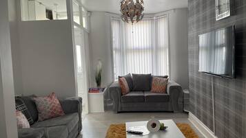 House, 2 Queen Beds | Living area | Flat-screen TV