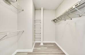 A compact space with a metal ladder and drying rack, perfect for functional storage.