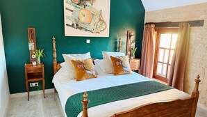 A bedroom with a wooden bed, green walls, a painting, and a window with curtains. - Charming cottage within a perigordine farmhouse  (Saint-Cyprien)