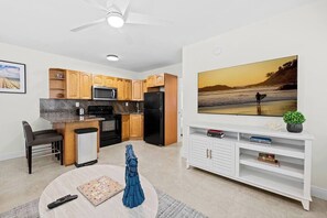 A modern kitchen with wooden cabinets, a microwave, and a refrigerator.