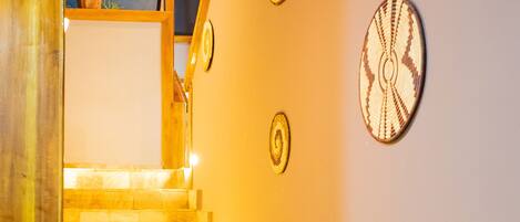 A staircase with stone steps and wall-mounted decorative plates.