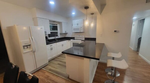 Enjoy cooking in this well-equipped kitchen with a central island and stove.