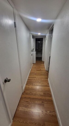 Stroll down this quiet hallway to a room.