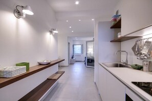 Modern kitchen with oven, stainless steel sink, and ample countertop space.