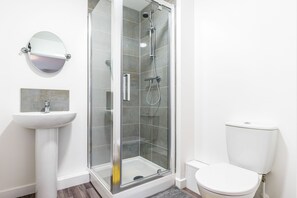 Shower, hair dryer, towels, toilet paper