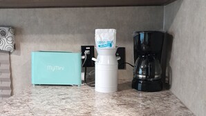 A kitchen counter with a coffee maker, a MyMini box, and a white container with a bag of coffee. - Lake House (Beechgrove)
