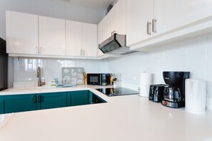 Deluxe Apartment | Private kitchen | Full-size fridge, dishwasher, coffee/tea maker, electric kettle