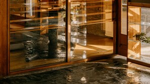 A wooden interior with a stone wall and a staircase leading to an upper level. - Parque do Rio Ofir Hotel (Esposende)