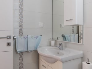 A bathroom with a sink, mirror, and towel rack. - Rooms Tupina by Paulina - Superior Double Room With Balcony and Sea View (Zupa dubrovacka)
