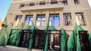 A modern building with a flat roof, large windows, and a balcony. - 85 sqm  in the Heart of Athens w/Rooftop Deck (Athens)