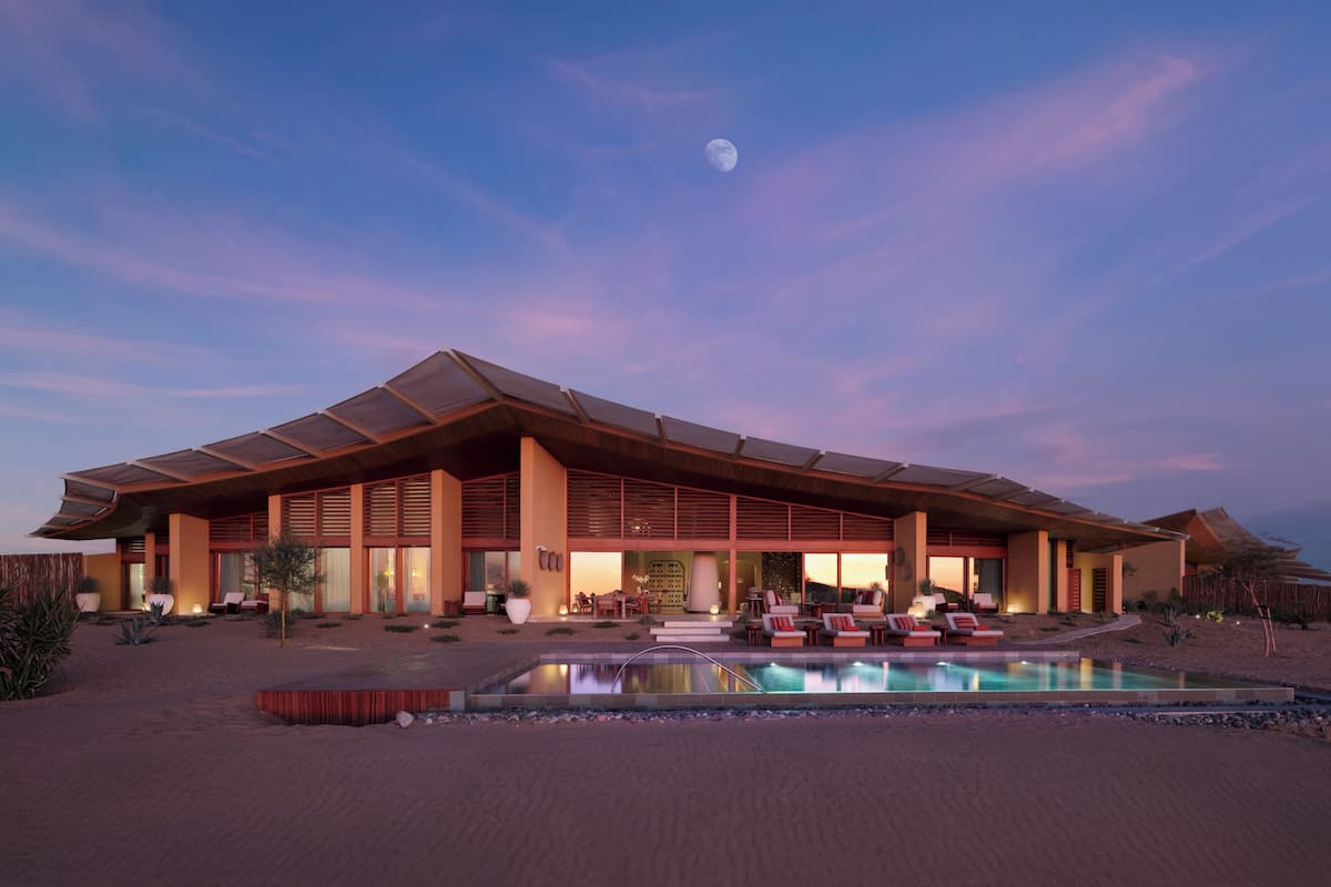 Relax by the resort's outdoor pool, surrounded by lounge chairs and a soothing waterfall.