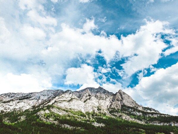 A mountain landscape with rocky peaks and a clear sky.