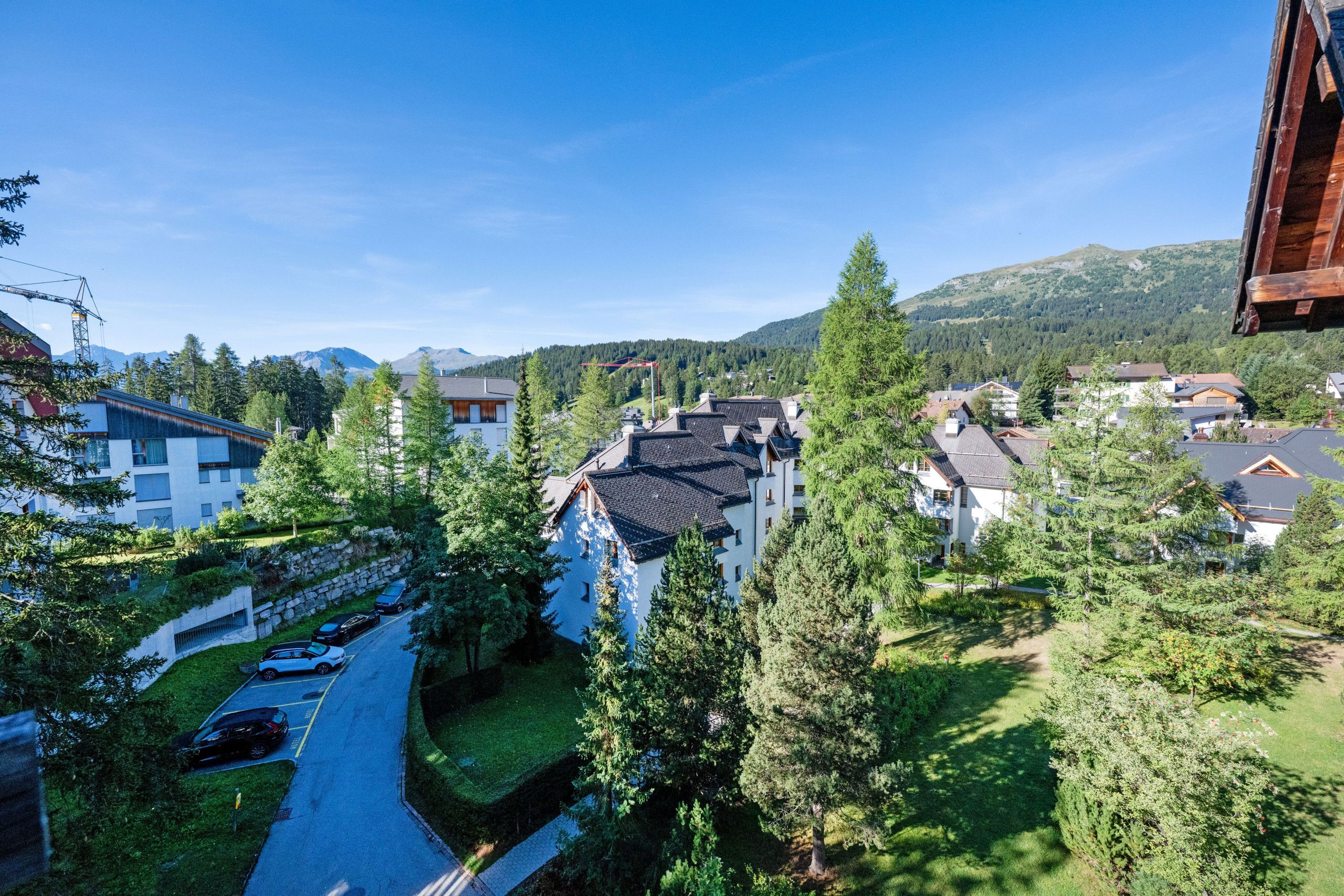 A residential area with houses, a road, and a mountain in the background.