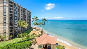 A hotel with multiple floors, a beach view, and palm trees. -   Dlx OCEANVIEW Maui  Studio..Updated!
West Maui. AC. Royal Kahana. (Lahaina)