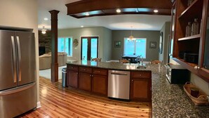 A modern kitchen with wooden flooring, granite countertops, stainless steel appliances, and a central island. - HORSE FARM ON PRIVATE 22 ACRES + TROUT POND (Canton)