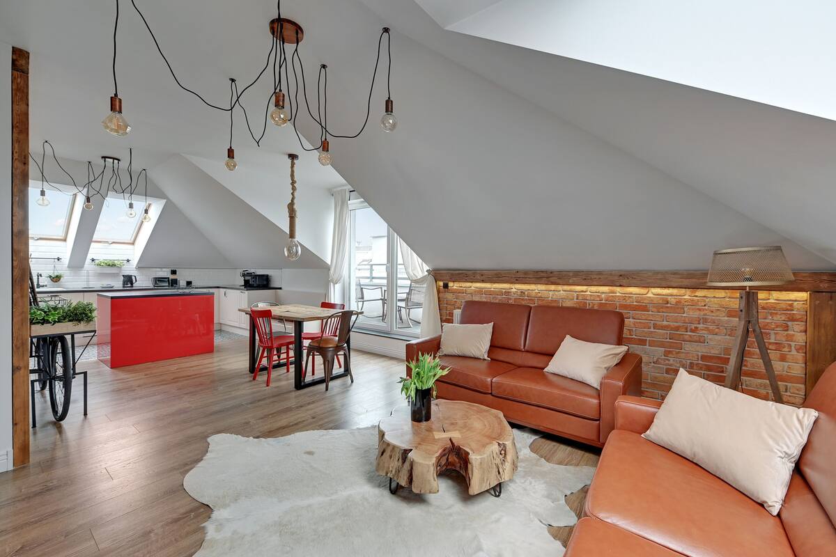 A loft-style living space with a kitchen, dining area, and seating area.