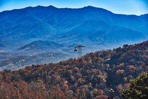 A mountainous landscape with a cable car system. - Romantic Smoky Mountain Condo Getaway (Gatlinburg)