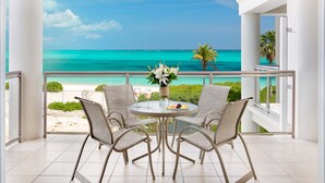 A balcony with a view of a beach and ocean. - OCEANFRONT GRACE BAY top floor Coral Gardens (Providenciales)