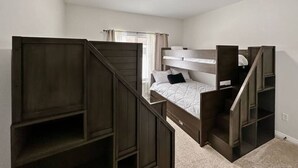 A bedroom with a bunk bed, a desk, and a staircase. - Relaxing Mountain Hideaway | Near Tamarack Resort (Donnelly)