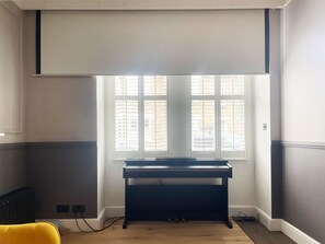 Enjoy music and views from the piano in this stylish room with a large window.