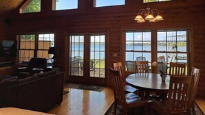 A cabin with a large dining table, a sofa, and a TV in the living area. - Tradewinds on Cormorant, Audubon, MN (Audubon)