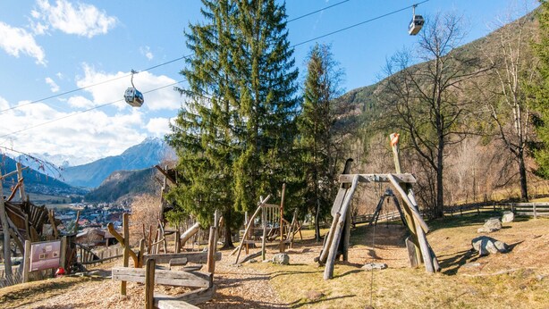 A mountain view with a wooden swing set, a cable car, and a forested area. - Modern Apartment in the Otztal (Oetz)