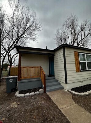 Guests can enjoy a front porch with steps leading to the entrance.