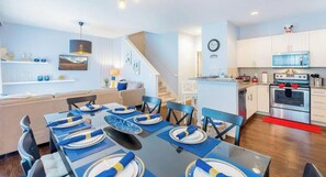 A modern kitchen with white cabinets, a stainless steel oven, and a microwave. - No Airbnb Fees! Themed Home Near Disney World! (Kissimmee)