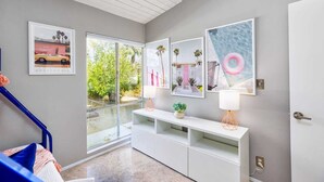 A modern interior with a staircase, a white console table, and framed artwork on the wall. - 25% Off Sept 10-12 Great 4 Families -Pool, Jacuzzi (Palm Springs)