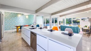 A modern kitchen with a large island, white cabinetry, and a teal backsplash. - 25% Off Sept 10-12 Great 4 Families -Pool, Jacuzzi (Palm Springs)