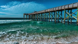 A pier extending into the ocean with clear skies. - High-Rise Ocean View Condo at Laketown Wharf 2012 (Panama City Beach)
