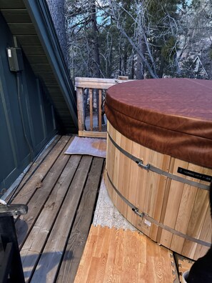 A hot tub with a wooden exterior and a label reading "Nordic Hot Tub."