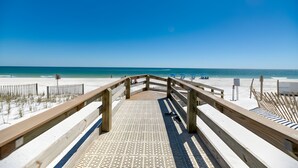 A wooden boardwalk leading to a beach with clear skies. - Uncrowded Corner Beachfront 3BR w/3 New Spa Baths (Gulf Shores)