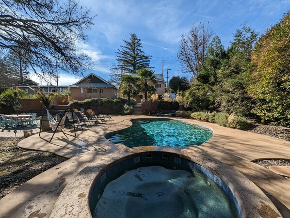 Relax by the pool surrounded by lush gardens and comfortable lounge seating.
